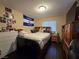 Cozy bedroom featuring wood floors, El Salvador flag, and large wooden dresser at 4612 Supreme Ct, Las Vegas, NV 89110