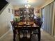 Charming dining room with elegant wooden table, display cabinet, and sliding door access to outdoor area at 4612 Supreme Ct, Las Vegas, NV 89110