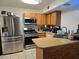 Well-equipped kitchen with stainless steel appliances, wood cabinets, and functional layout for cooking at 4612 Supreme Ct, Las Vegas, NV 89110