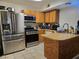 Well-equipped kitchen with stainless steel appliances, wood cabinets, and functional layout for cooking at 4612 Supreme Ct, Las Vegas, NV 89110