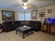 Spacious living room with tile flooring, comfortable seating, and a ceiling fan at 4612 Supreme Ct, Las Vegas, NV 89110