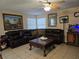 Spacious living room with tile flooring, comfortable seating, and a ceiling fan at 4612 Supreme Ct, Las Vegas, NV 89110
