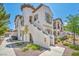 Charming two-story home featuring a unique staircase and landscaped front yard with colorful flowers at 50 Aura De Blanco St # 2104, Henderson, NV 89074