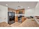 This kitchen features wood cabinets, granite counters, and stainless steel appliances at 50 Aura De Blanco St # 2104, Henderson, NV 89074