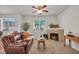 Cozy living room with a comfortable leather sofa, a fireplace, and lots of natural light at 50 Aura De Blanco St # 2104, Henderson, NV 89074
