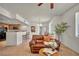 Living room is open to the kitchen with tile floors and a view of the breakfast bar at 50 Aura De Blanco St # 2104, Henderson, NV 89074