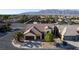 Aerial view of the house showing a well-maintained lawn, landscaping, and a three-car garage at 5016 Wayfaring Tree Ave, Las Vegas, NV 89131