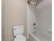 This bathroom features a shower over the tub with white tile surround, a toilet and neutral wall color at 5016 Wayfaring Tree Ave, Las Vegas, NV 89131