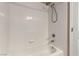 Bathroom featuring a tub and shower combo with white tile and neutral accents at 5016 Wayfaring Tree Ave, Las Vegas, NV 89131