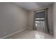 Bedroom with tile flooring, neutral walls, and a window with modern shades and curtains at 5016 Wayfaring Tree Ave, Las Vegas, NV 89131