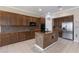 Spacious kitchen featuring granite counters, an island with seating, and stainless steel appliances at 5016 Wayfaring Tree Ave, Las Vegas, NV 89131