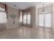 Open-concept room with tile floor, decorative window coverings and a glass door to the backyard at 5016 Wayfaring Tree Ave, Las Vegas, NV 89131