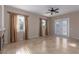 Spacious living room with tile flooring, a ceiling fan, and sliding glass doors to the exterior at 5016 Wayfaring Tree Ave, Las Vegas, NV 89131