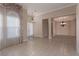 Open-concept living and dining area with tile floors and decorative lighting at 5016 Wayfaring Tree Ave, Las Vegas, NV 89131