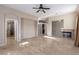 Open living room with a fireplace, tile flooring, and an arched entry to another room at 5016 Wayfaring Tree Ave, Las Vegas, NV 89131