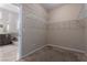 Walk-in closet with built-in shelving and carpeted flooring, leading into a bathroom at 5016 Wayfaring Tree Ave, Las Vegas, NV 89131