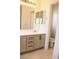 Bright bathroom with a vanity with drawers and cabinet, toilet, and a large mirror at 5112 Foggia Ave, Las Vegas, NV 89130