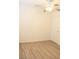 Bedroom with neutral paint and wood-look floors features ceiling fan and closet at 5112 Foggia Ave, Las Vegas, NV 89130