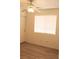 Bright bedroom features wood-look flooring, a ceiling fan and a window with blinds at 5112 Foggia Ave, Las Vegas, NV 89130