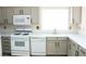 Clean and modern kitchen with white appliances, sleek countertops, and bright natural light at 5112 Foggia Ave, Las Vegas, NV 89130