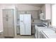 Well-lit kitchen features white appliances, ample cabinetry, and modern hardware at 5112 Foggia Ave, Las Vegas, NV 89130