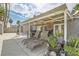 Backyard patio with lounge chairs, dining table, potted plants, and covered area, perfect for outdoor living at 5217 Champions Ave, Las Vegas, NV 89142