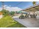 Expansive backyard with pool, large patio area, seating, green grass, and mature trees, ideal for entertaining at 5217 Champions Ave, Las Vegas, NV 89142