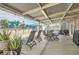 Outdoor patio with dining area, lounge chairs, barbecue, potted plants, and access to a pool at 5217 Champions Ave, Las Vegas, NV 89142