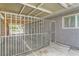 Backyard enclosed with a metal rail fence. Includes partial view of the home and a yard beyond the fence at 5217 Champions Ave, Las Vegas, NV 89142