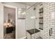 Modern bathroom features a glass enclosed shower, subway tile, and updated lighting at 5217 Champions Ave, Las Vegas, NV 89142