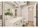 Modern bathroom with marble countertops, white vanity, and neutral tile flooring at 5217 Champions Ave, Las Vegas, NV 89142
