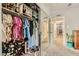 Spacious walk-in closet with ample storage, shelving, and mirrored doors for organized living at 5217 Champions Ave, Las Vegas, NV 89142