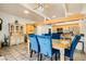Open concept living room with a dining room featuring blue chairs and tile floors at 5217 Champions Ave, Las Vegas, NV 89142