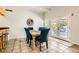 Dining room with blue chairs, tile floors, and access to a patio at 5217 Champions Ave, Las Vegas, NV 89142