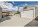 Spacious backyard with large concrete pad, detached garage with basketball hoop, and pool area in the background at 5217 Champions Ave, Las Vegas, NV 89142