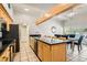 Modern kitchen features a center island with granite countertops and seating at 5217 Champions Ave, Las Vegas, NV 89142