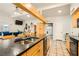 Bright kitchen features granite counters, stainless sink, light wood cabinets and an eat-in dining area at 5217 Champions Ave, Las Vegas, NV 89142