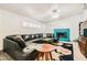 Cozy living room with a teal-painted fireplace, shuttered windows, and modern decor at 5217 Champions Ave, Las Vegas, NV 89142