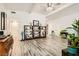 Open living room with wood laminate flooring, a vaulted ceiling, and bright white walls at 5217 Champions Ave, Las Vegas, NV 89142