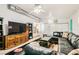 Spacious living room with a ceiling fan, modern decor, and comfortable leather seating at 5217 Champions Ave, Las Vegas, NV 89142