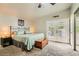 Bright main bedroom featuring double doors to the backyard, carpet flooring, and a walk-in closet at 5217 Champions Ave, Las Vegas, NV 89142
