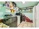 Ample storage room with shelving, tile flooring, laundry appliances, and painted in a light tone at 5217 Champions Ave, Las Vegas, NV 89142
