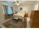 Cozy bedroom features neutral walls, floral accents, a decorative rug, and natural light from a window at 5424 Comchec Way # 101, Las Vegas, NV 89108