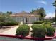Well-maintained single-story home with a red tile roof, manicured landscaping, and a sidewalk at 5424 Comchec Way # 101, Las Vegas, NV 89108
