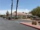 Charming single-story home with a red tile roof, mature landscaping, and a paved parking lot at 5424 Comchec Way # 101, Las Vegas, NV 89108