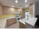 Bright kitchen with modern appliances, tiled countertops and ample cabinet space at 5424 Comchec Way # 101, Las Vegas, NV 89108