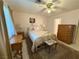 Comfortable bedroom with ceiling fan, plush bedding, and classic furnishings at 5424 Comchec Way # 101, Las Vegas, NV 89108