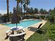 Community pool offers a relaxing space with lounge chairs and picnic tables at 5424 Comchec Way # 101, Las Vegas, NV 89108