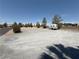 Large vacant lot with gravel surface, mature trees, and space for potential development, complete with RV parking spot at 5424 Comchec Way # 101, Las Vegas, NV 89108
