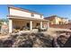 Spacious backyard featuring a covered patio and low-maintenance desert landscaping at 6052 Puesta Del Sol St, North Las Vegas, NV 89081